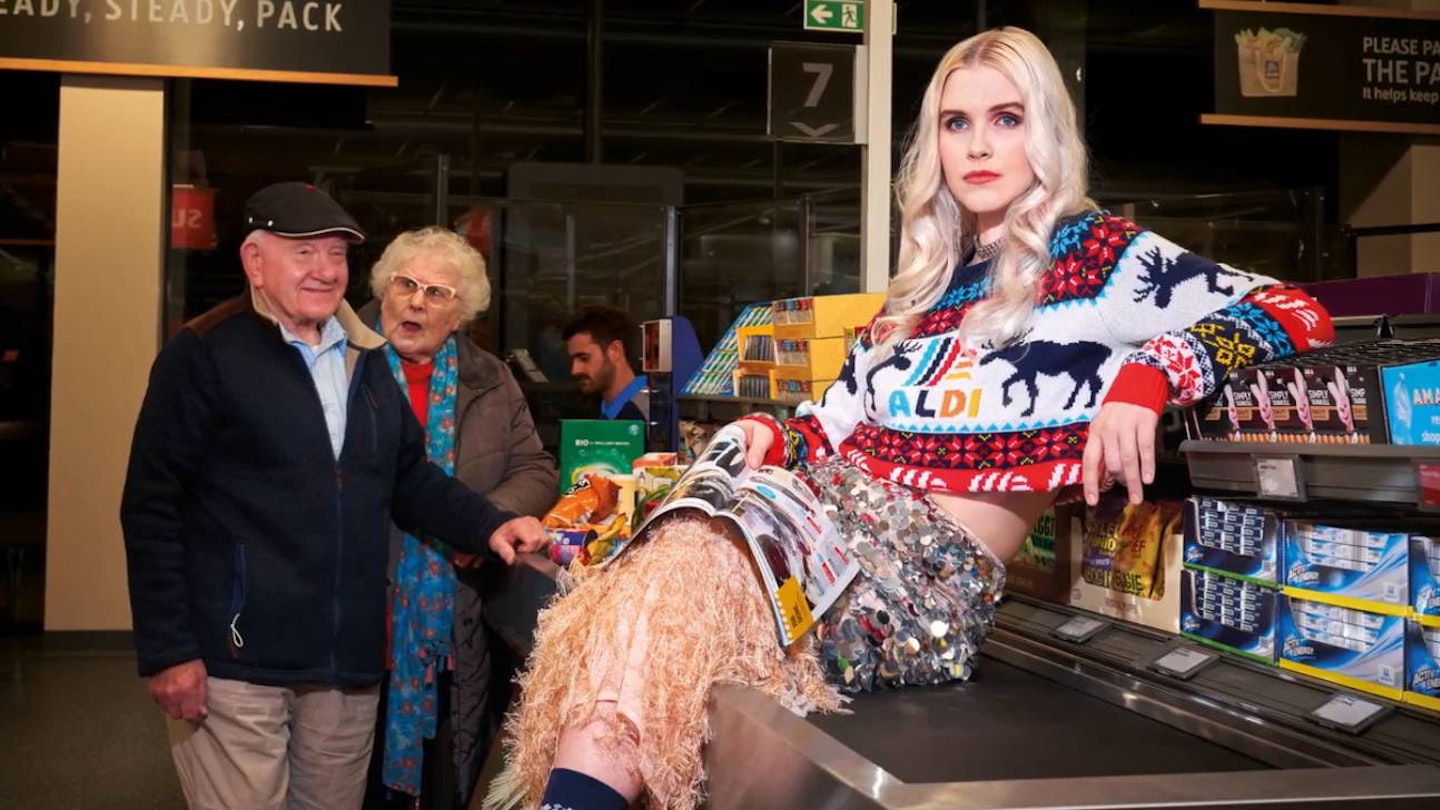 A model wearing a colourful Christmas jumper from Aldi