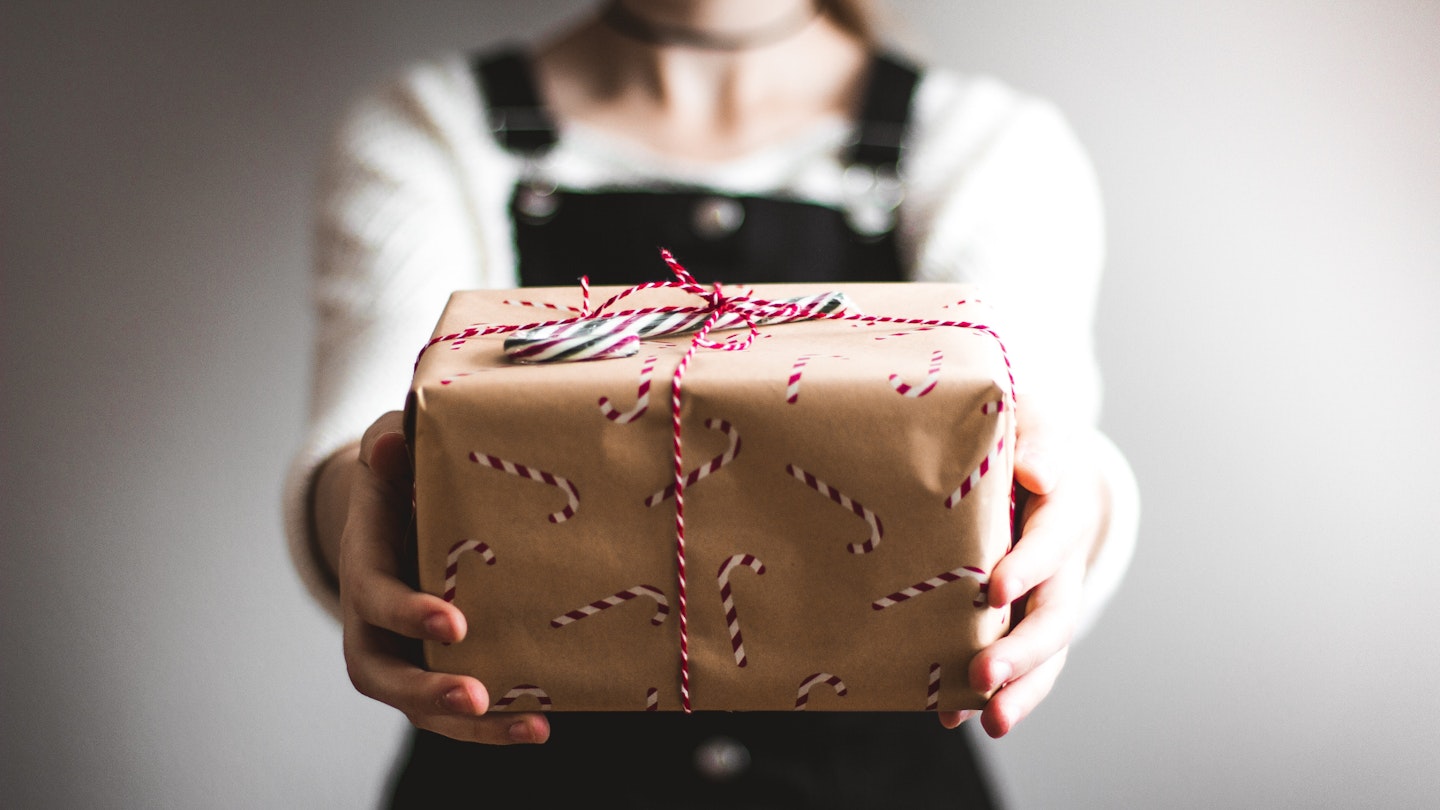 A woman holding a wrapped present
