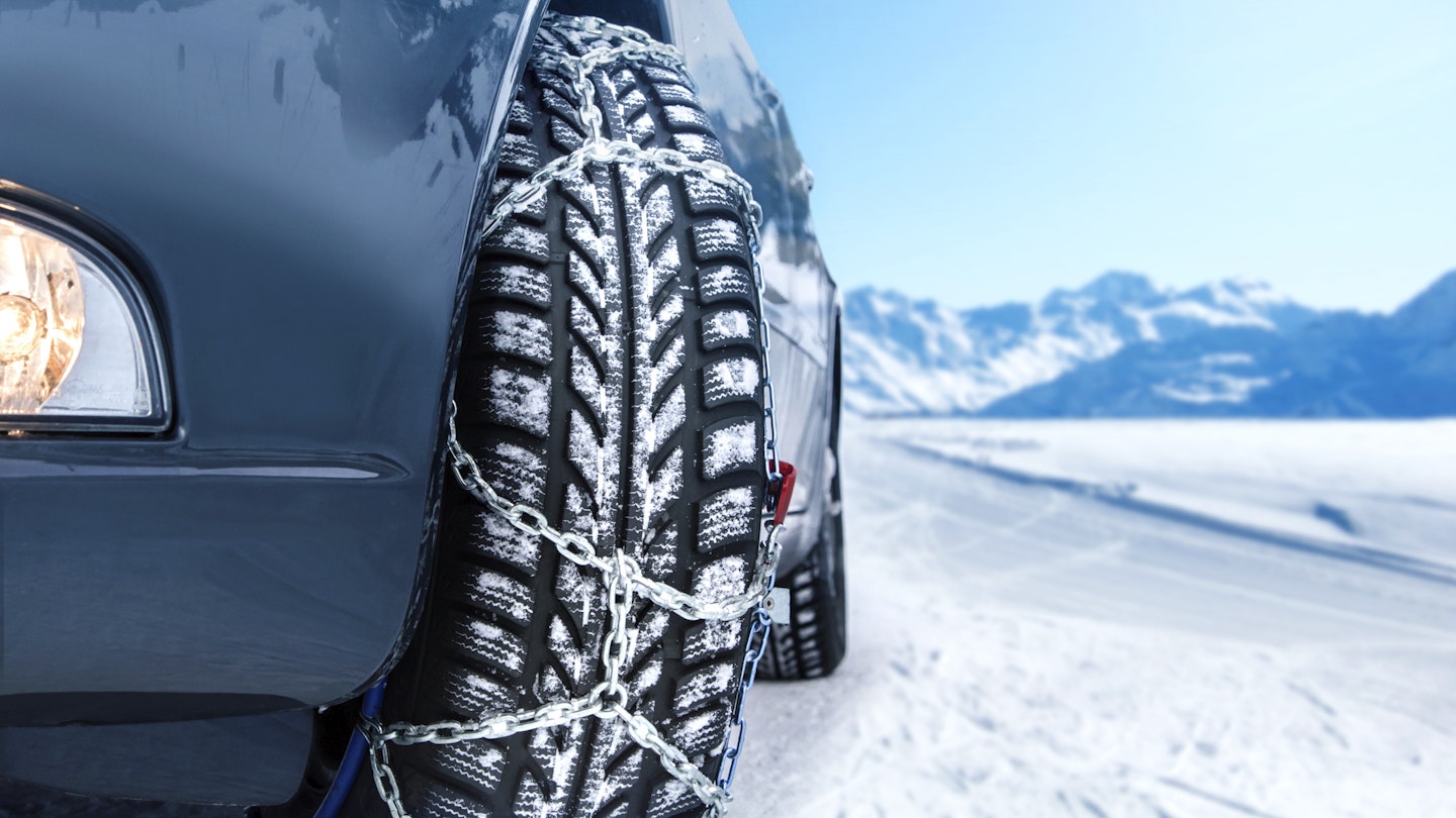 A car fitted with snow chains
