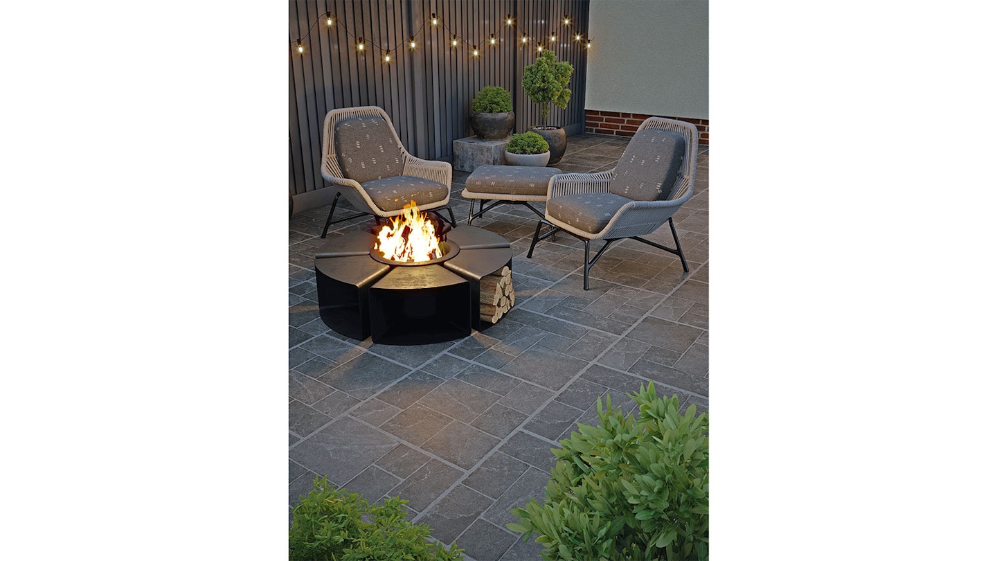 modular porcelain paving on patio with fire pit and festoons