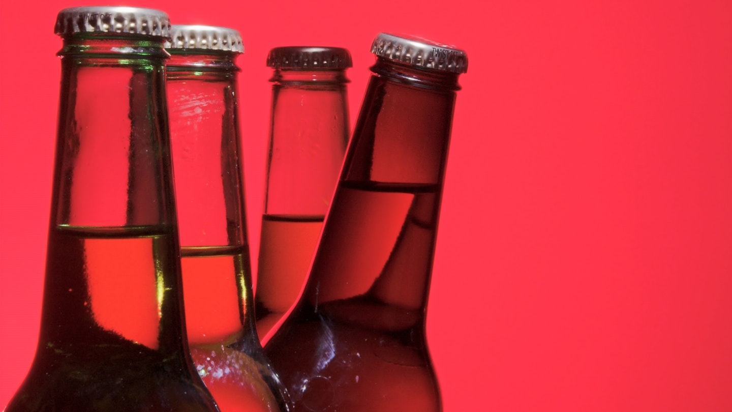 Unlabelled beer bottles with a red background