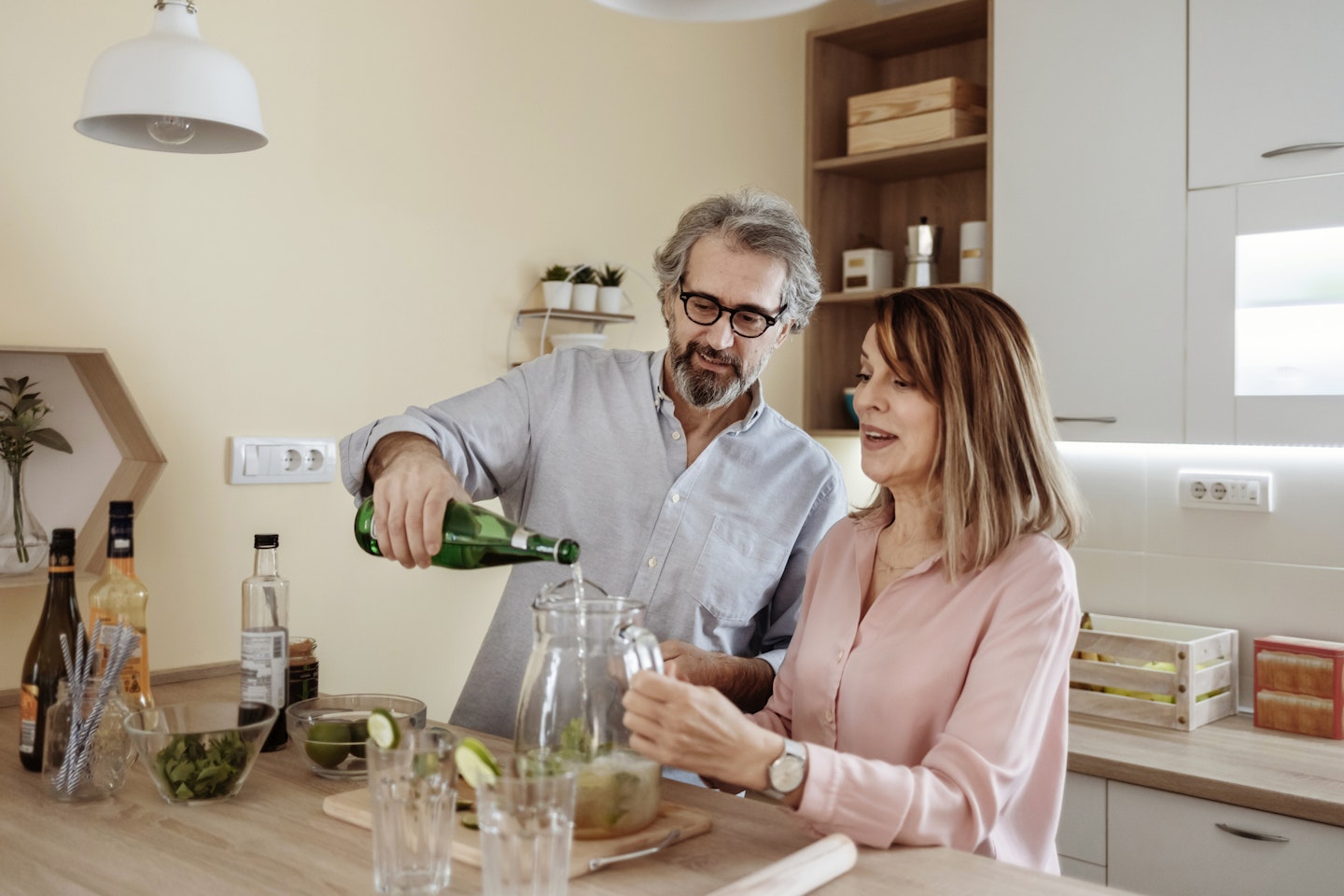 Couple making cocktails