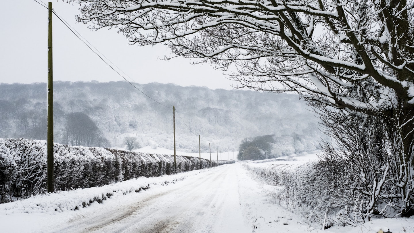 Empty snow-covered UK country road