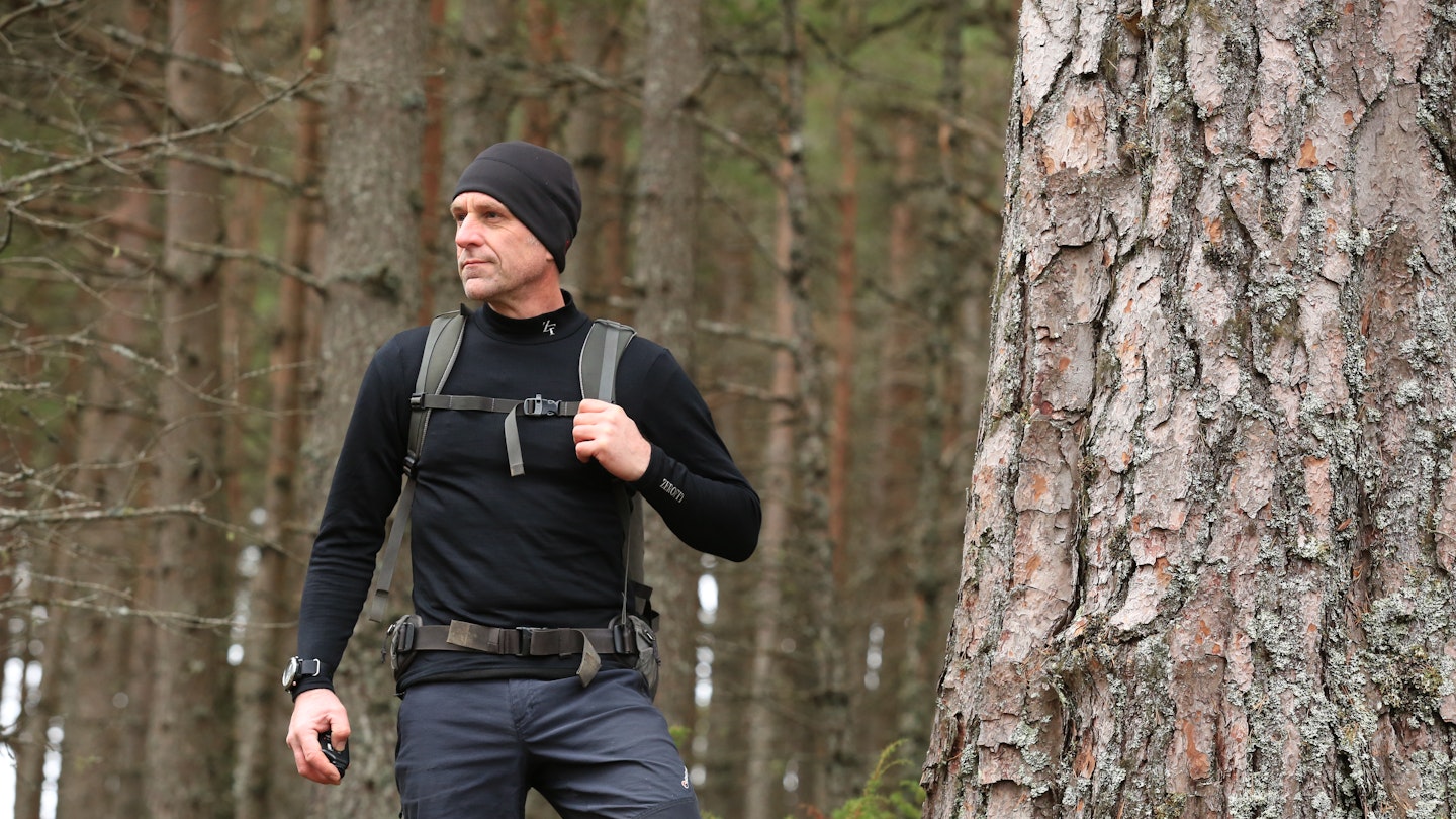 Hiker wearing base layer in Scottish Highlands forest