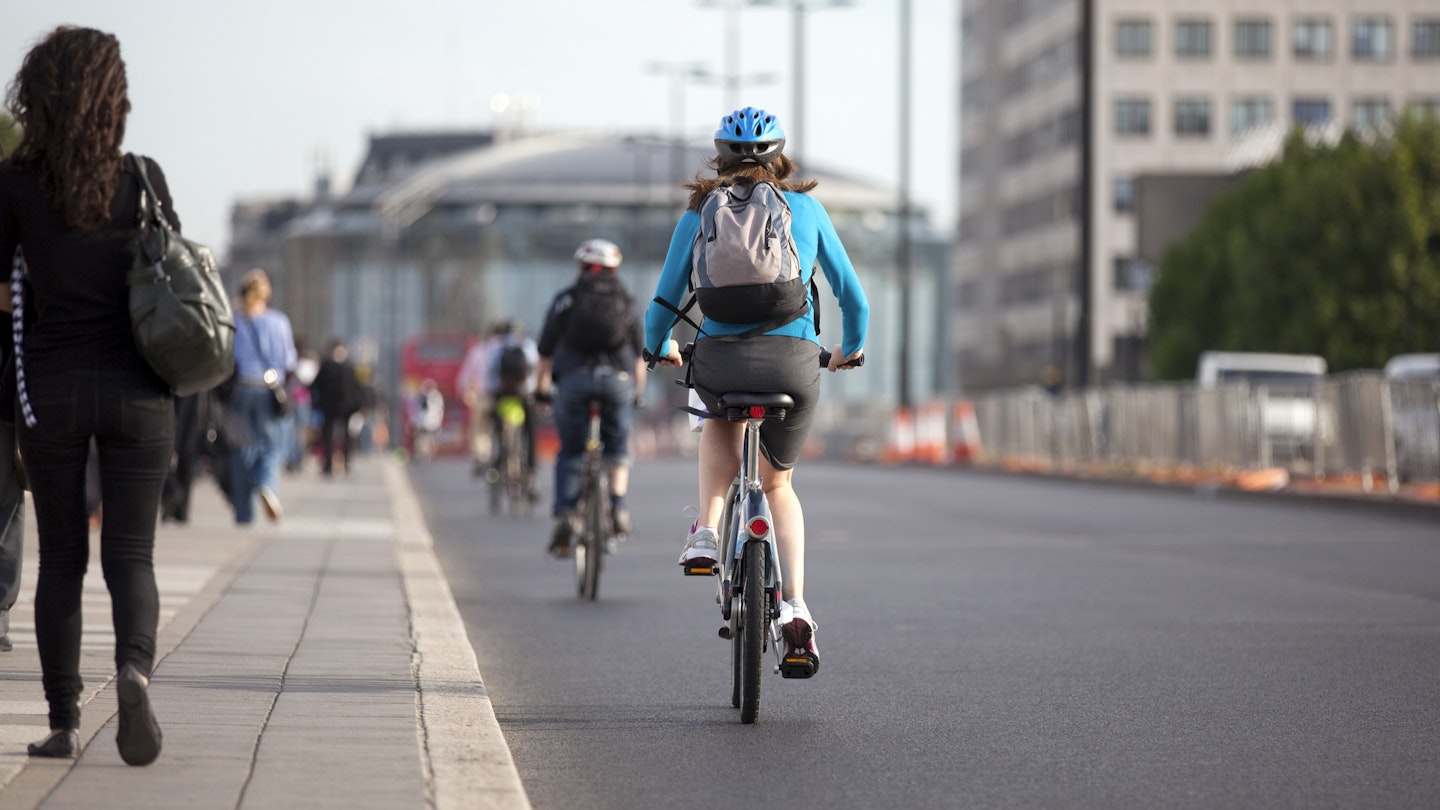 Commuter cycling over Waterloo Bridge