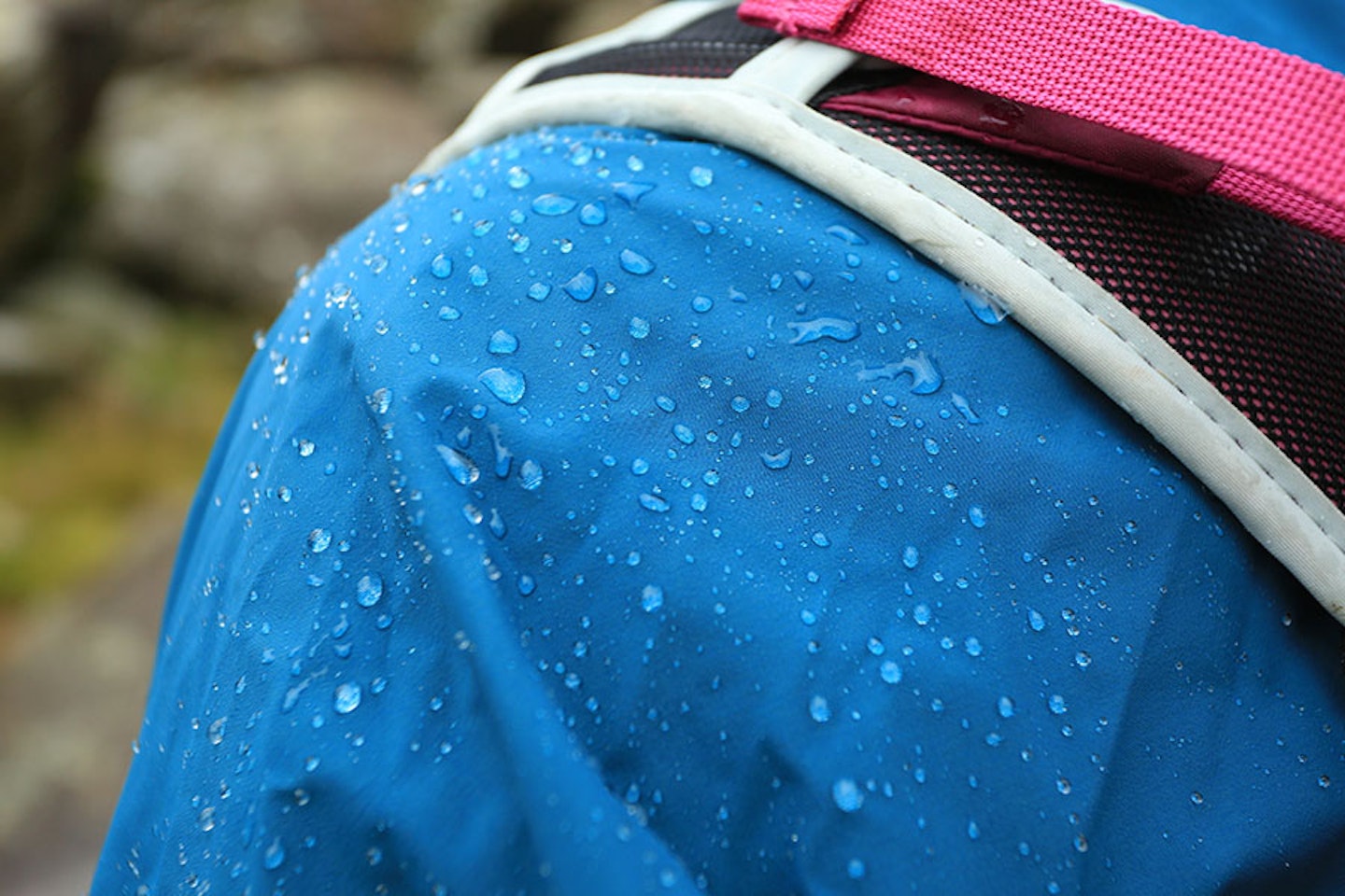 rain beading up on the shoulder of a waterproof hiking jacket