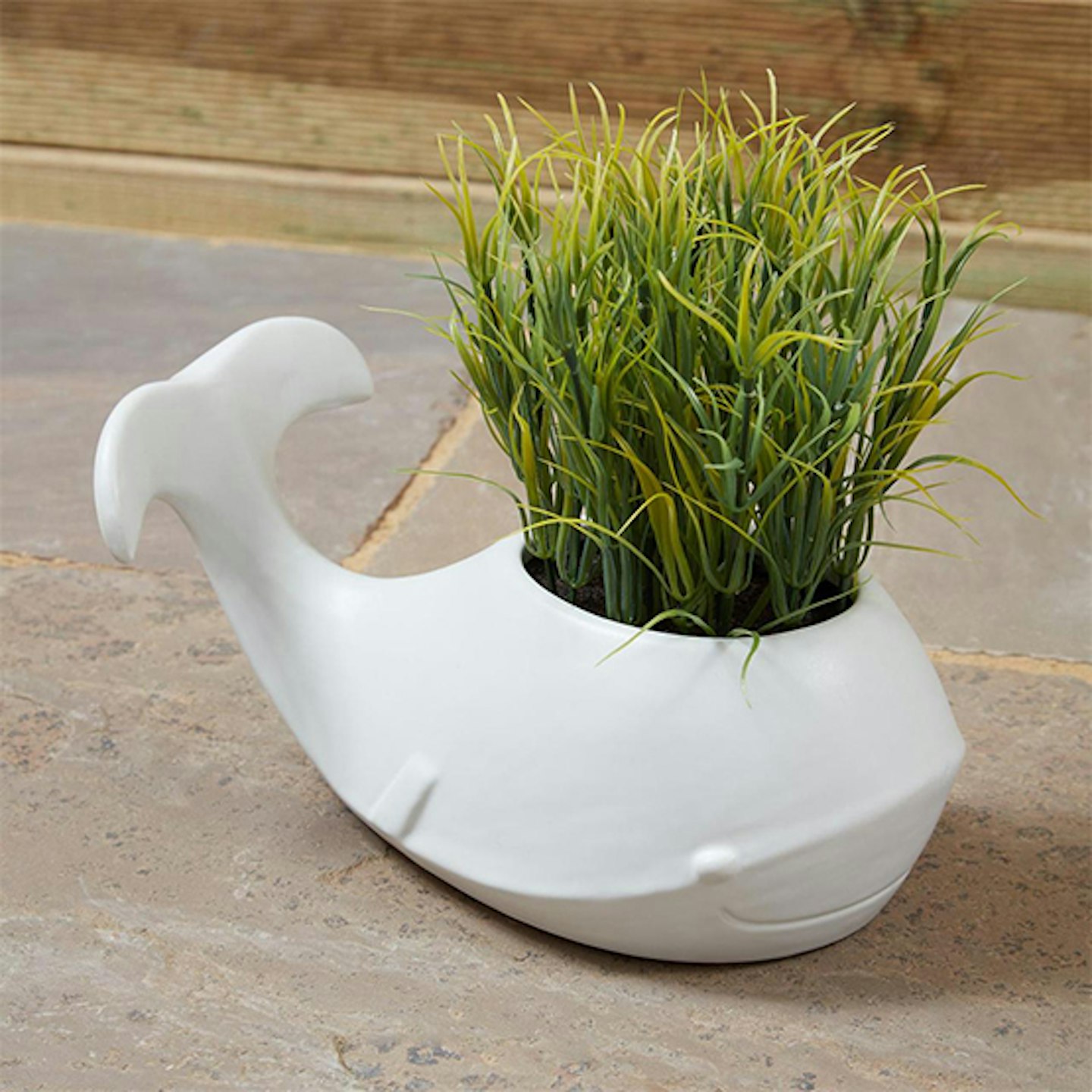 Grass in white ceramic whale