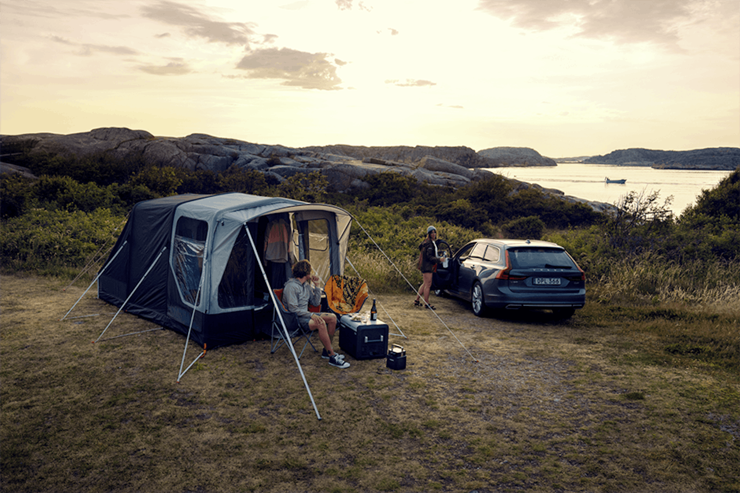 tent and car camping near a lake or by the sea