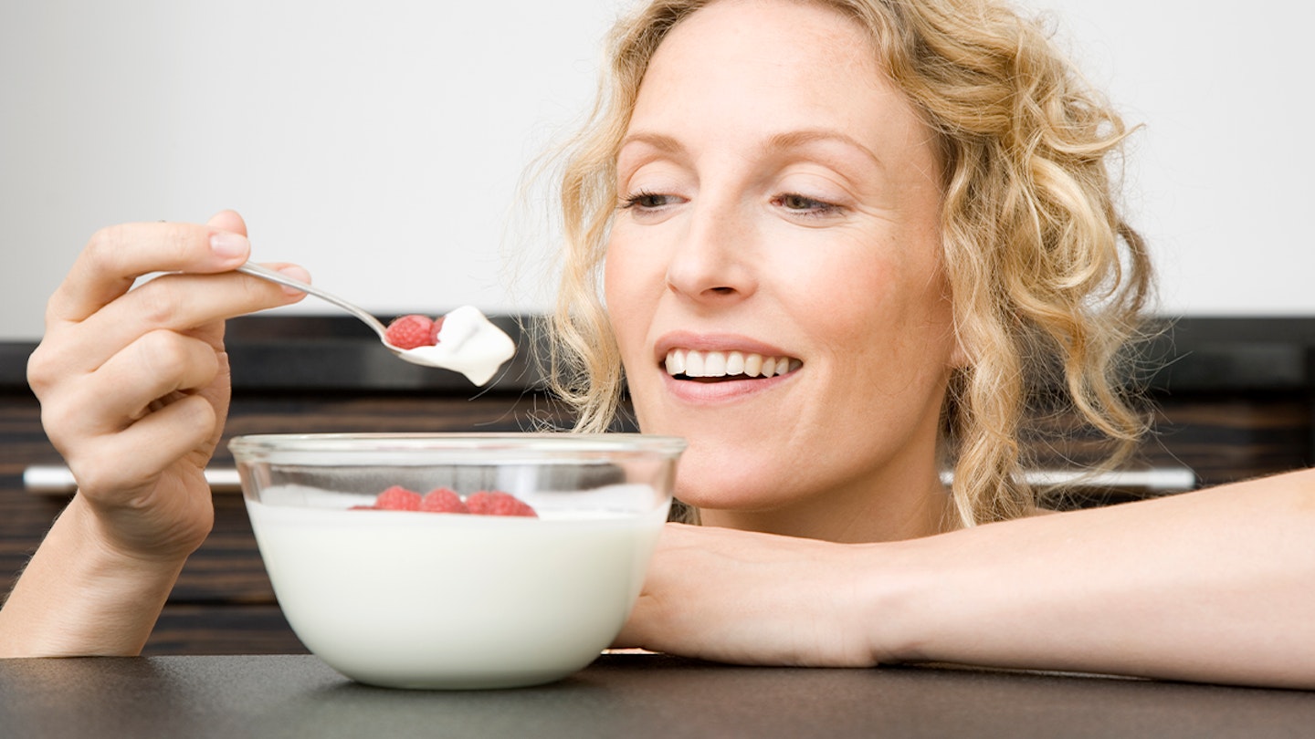 Woman eating a bowl of yoghurt