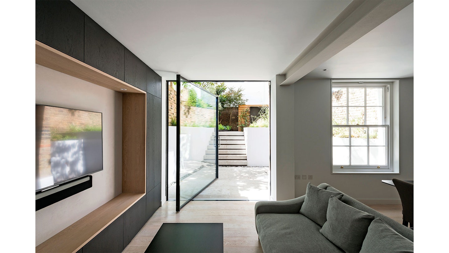 pivot door between kitchen and modern garden