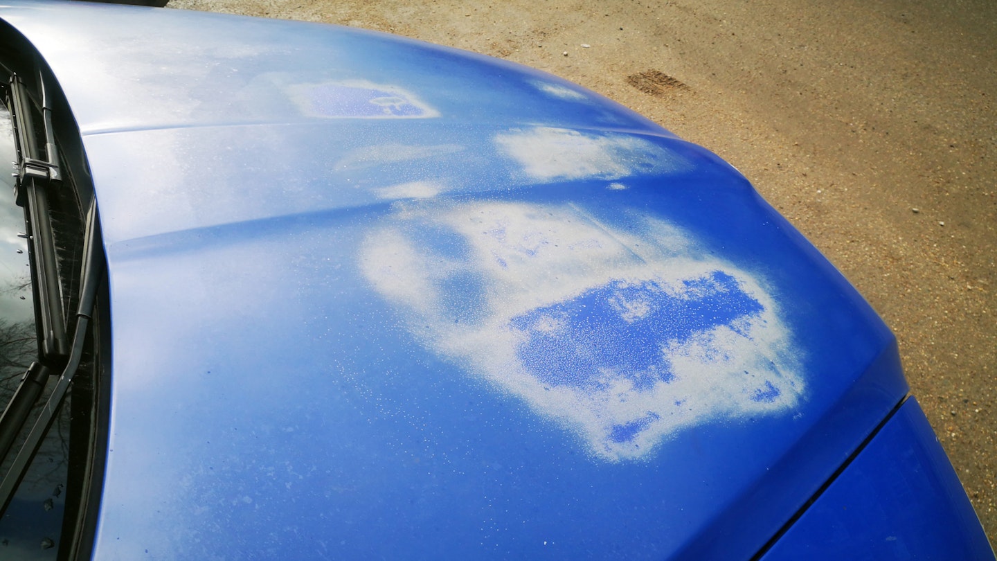 Oxidised paint on the bonnet of a blue car
