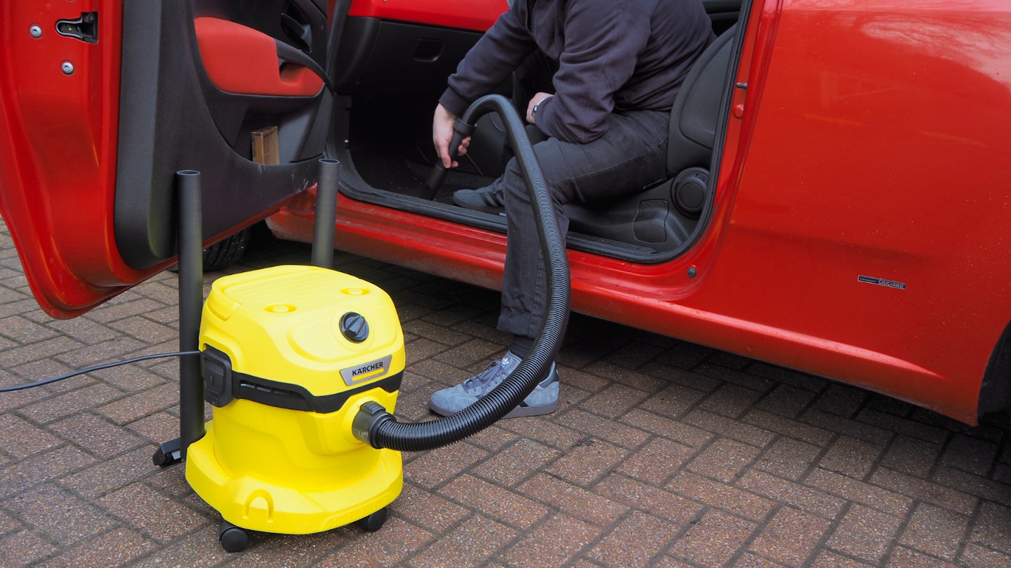 Karcher WD 2 Plus vacuuming a car interior