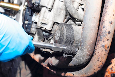 Removing a motorcycle oil filter with a strap wrench