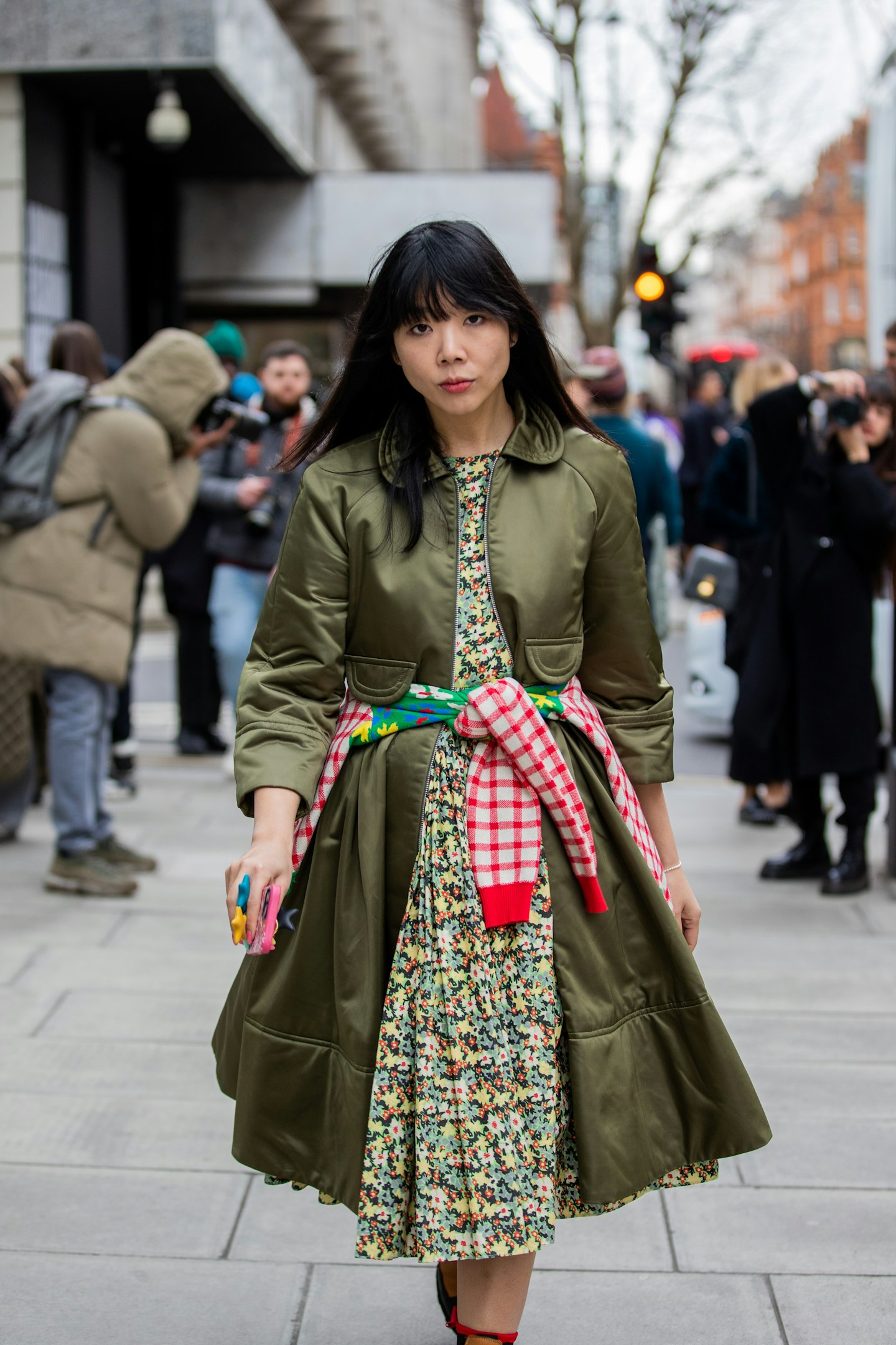 Susie Lau cinched her khaki coat with a playfully printed jumper