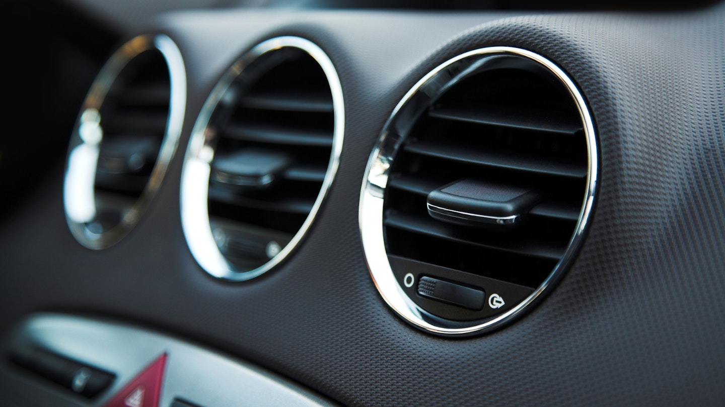 Three circular air vents in a car dashboard