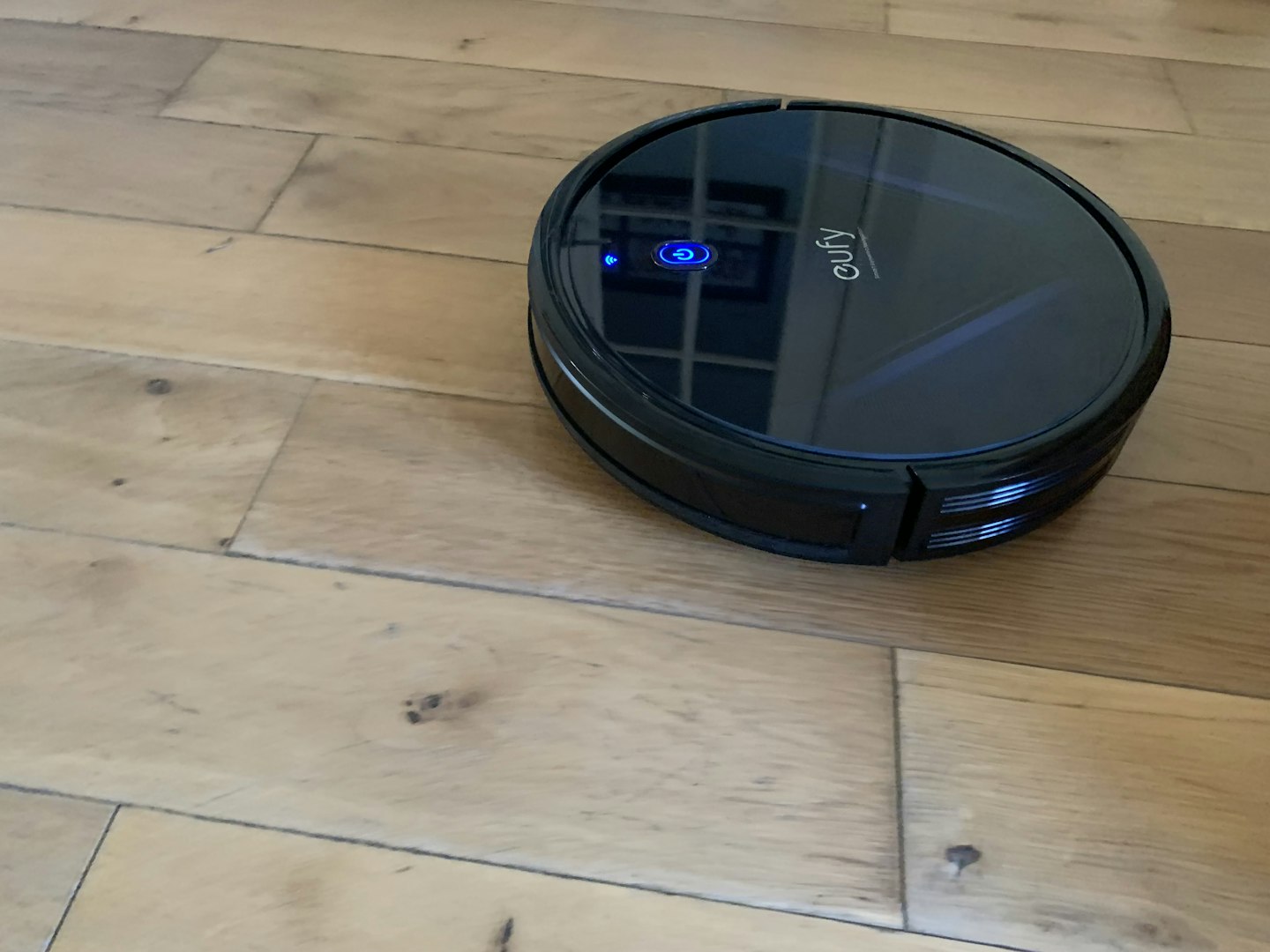 view of the G20 Robovac in action on a wooden hard floor.