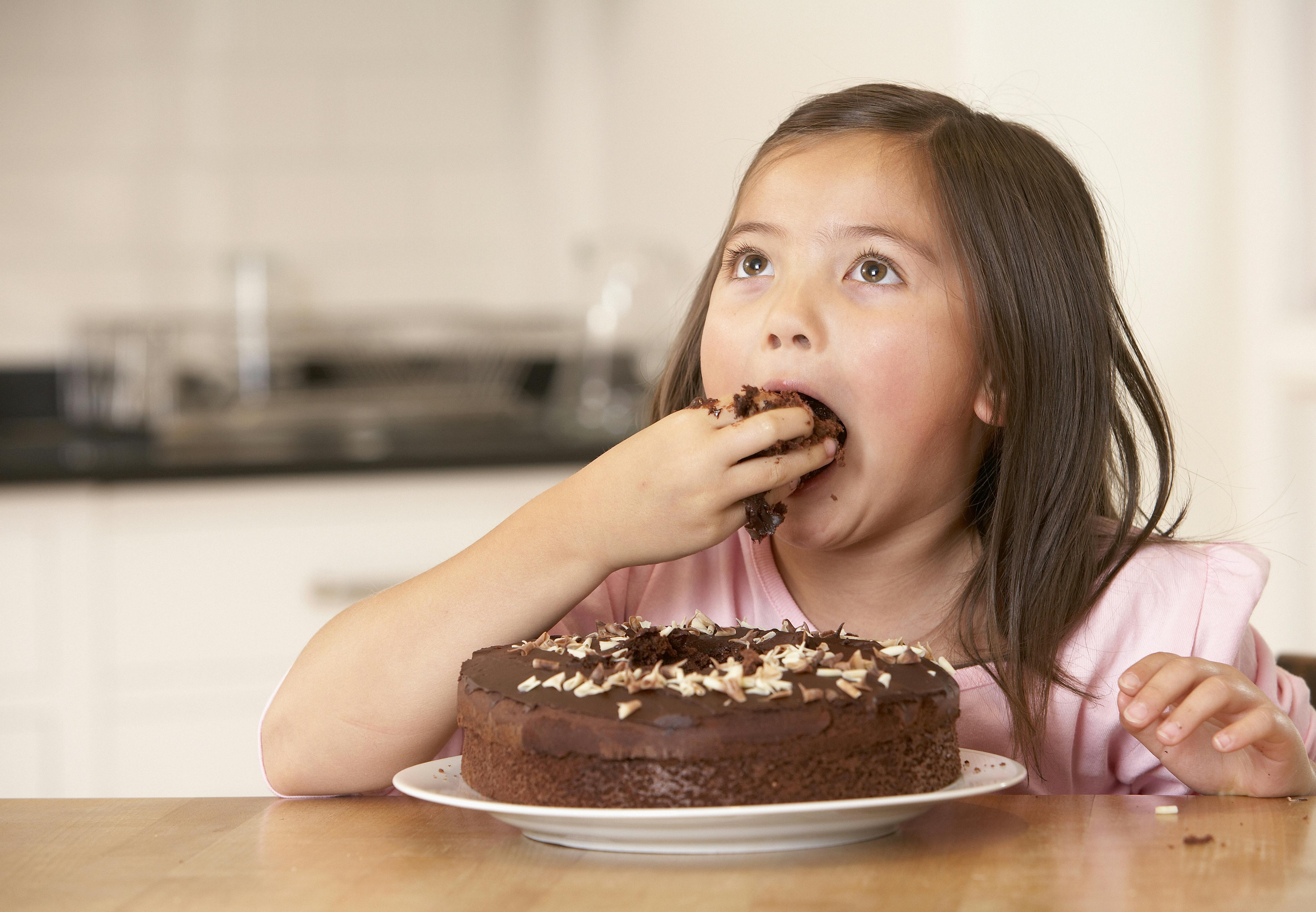 kid eats chocolate cake - HealthWorks Malaysia