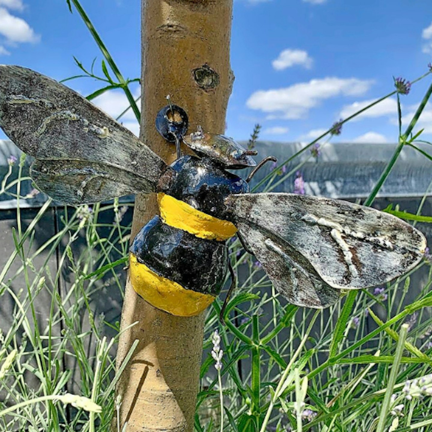 bumblebee sculpture on tree on sunny garden