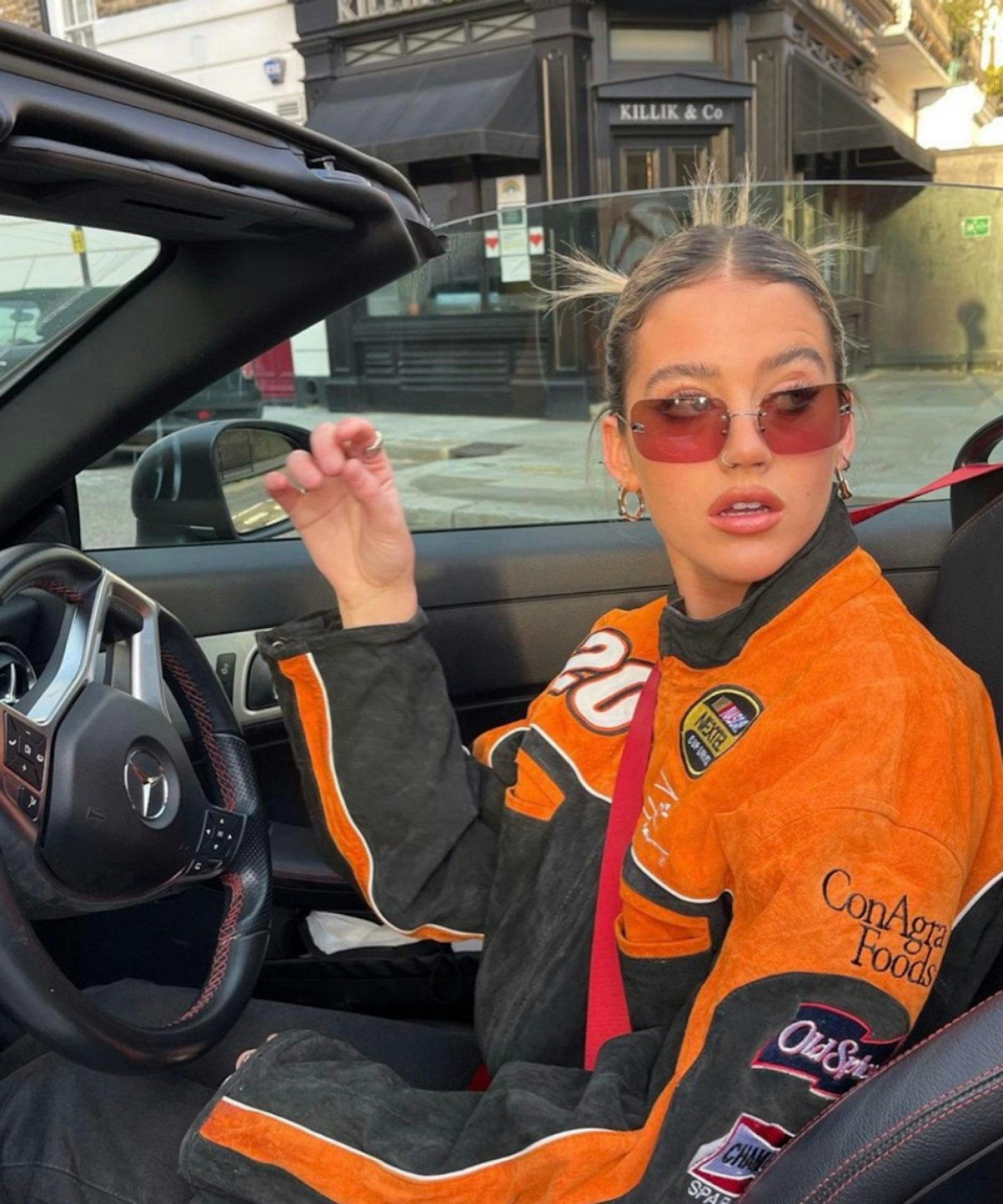 olivia-neill-outfit-instagram-NASCAR-motorbike-jacket-orange-posh-customs