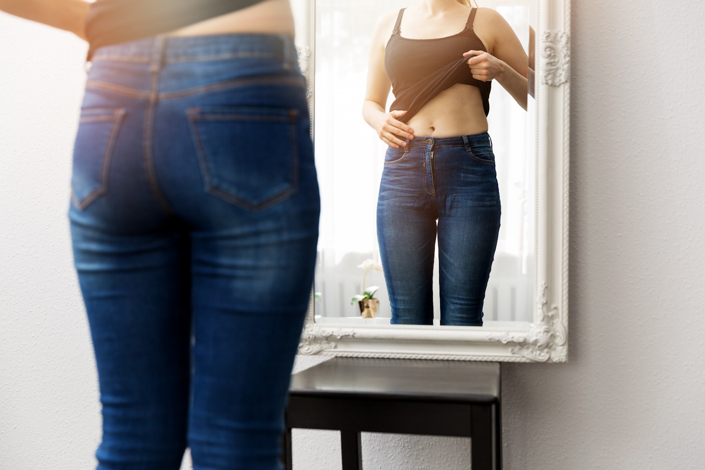 Woman looking at bely fat