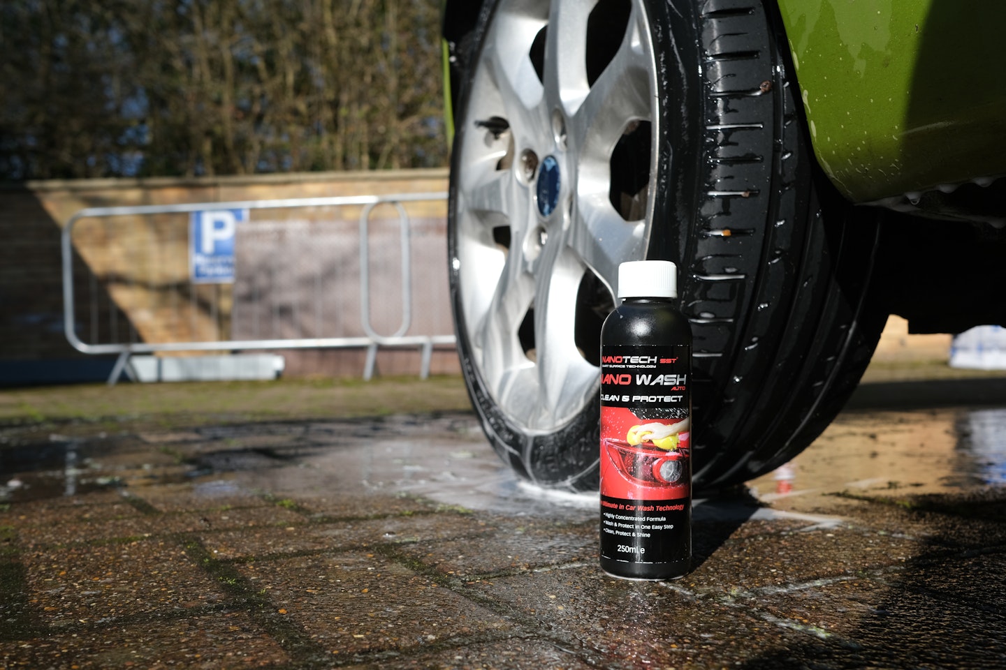 The Nano Wash bottle near a wheel