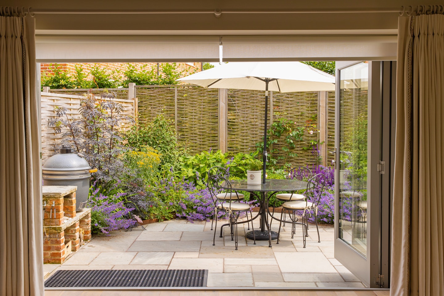 Delightful patio area with pizza oven, barbecue and garden furniture