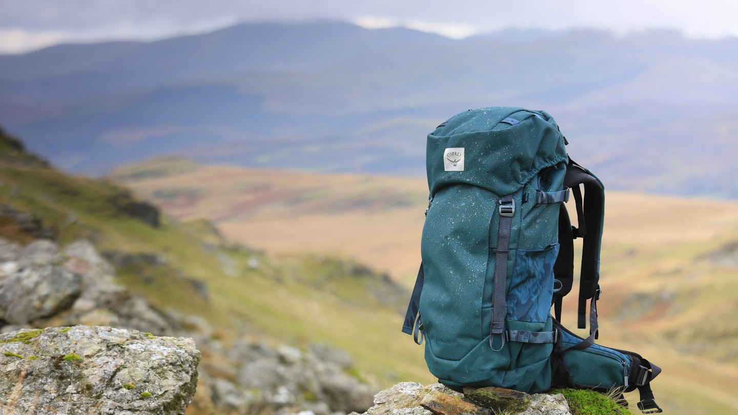 Wet Osprey hiking pack on a rock