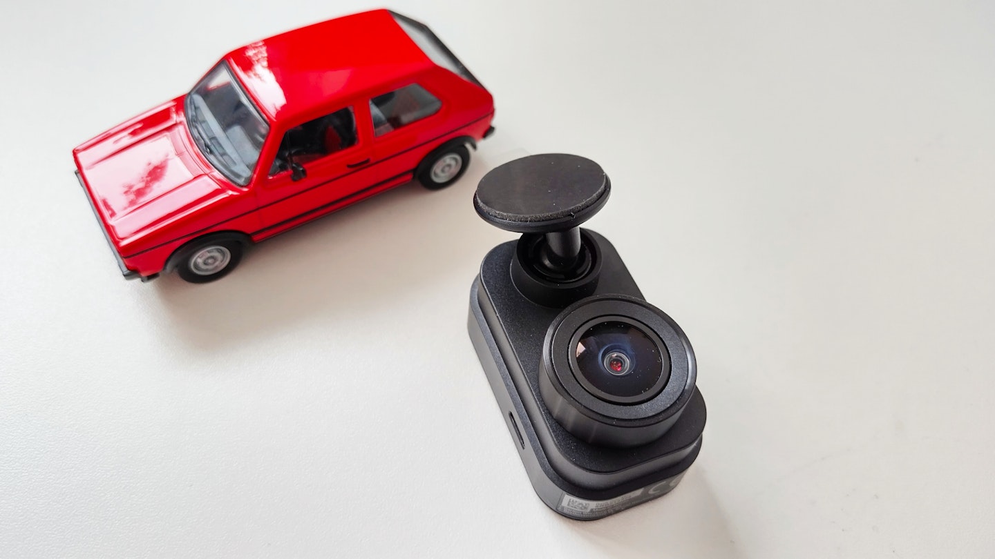 Garmin Dash Cam Mini 2 next to a red toy car