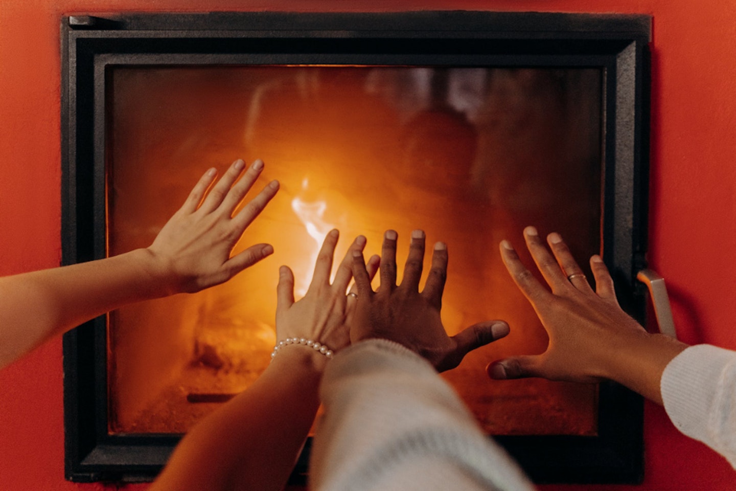 A family gathered around an electric fireplace
