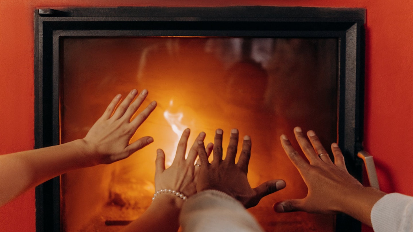 A family gathered around an electric fireplace