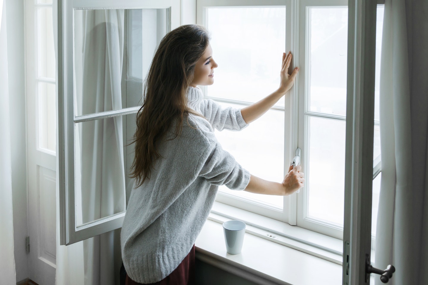 woman closing window