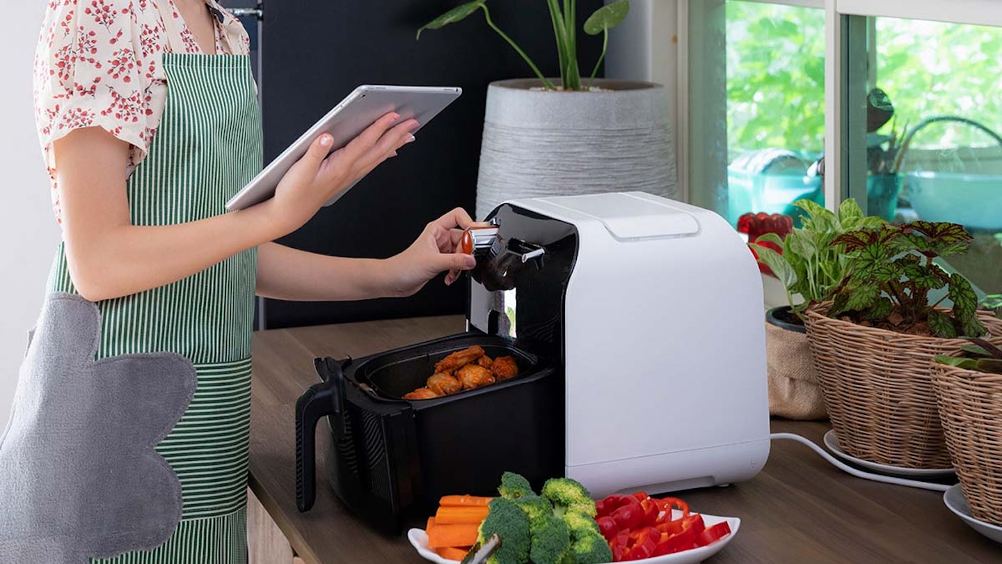woman using airfryer