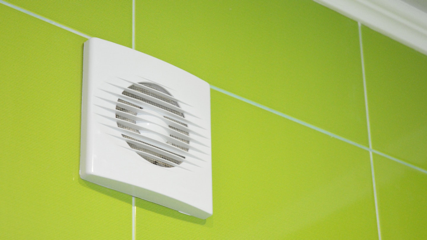 A Bathroom extractor fan on a tiled wall