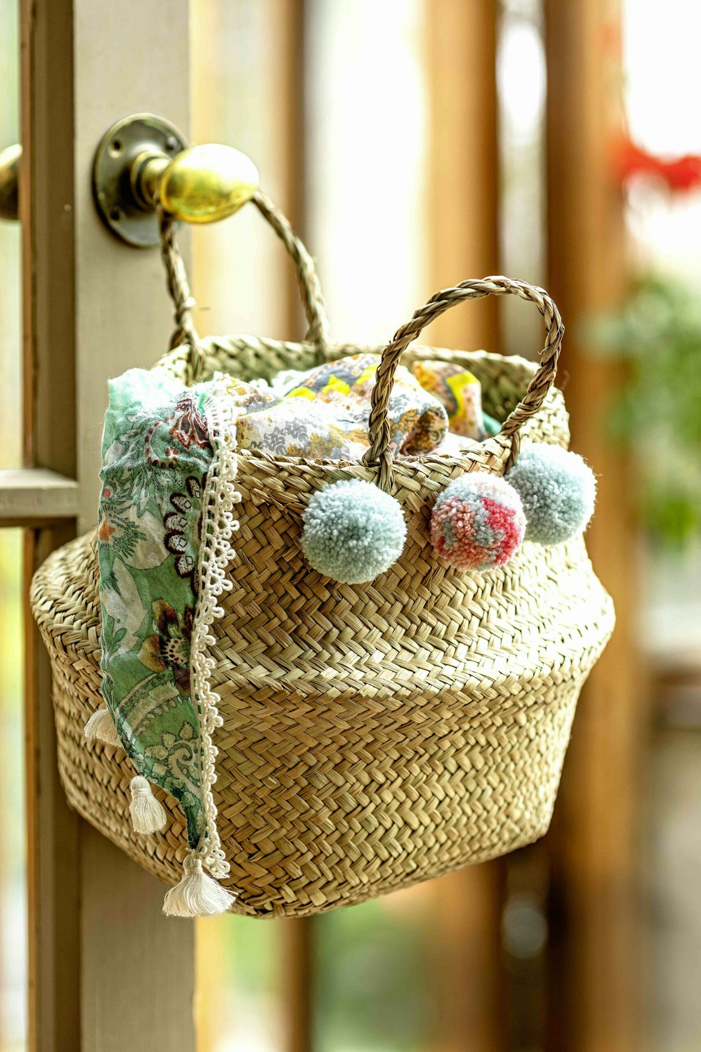 A summer basket adorned with colourful pompoms