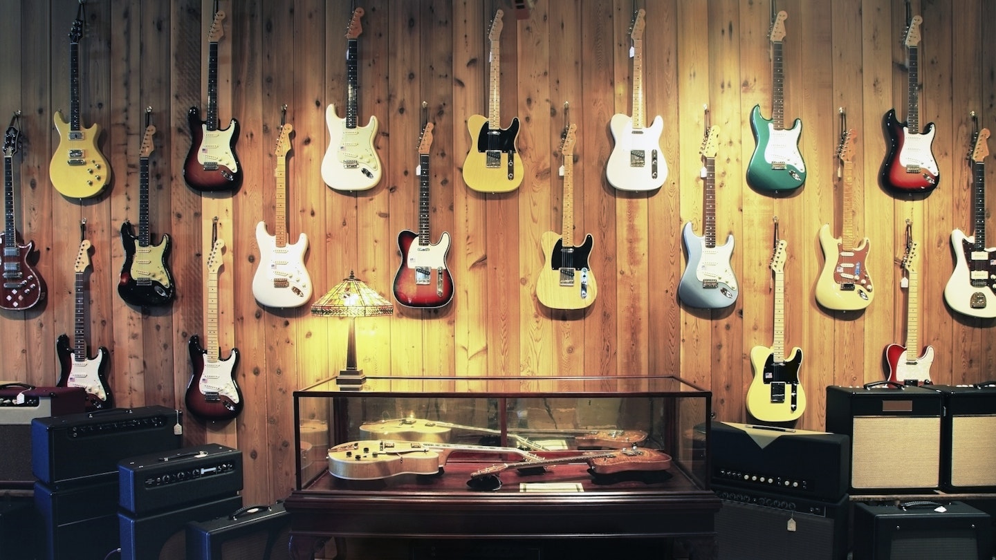 A guitar display featuring Fender guitars