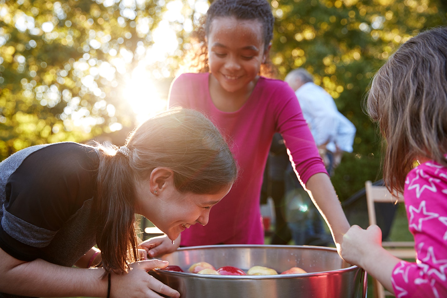 Children playing bobbing for apples