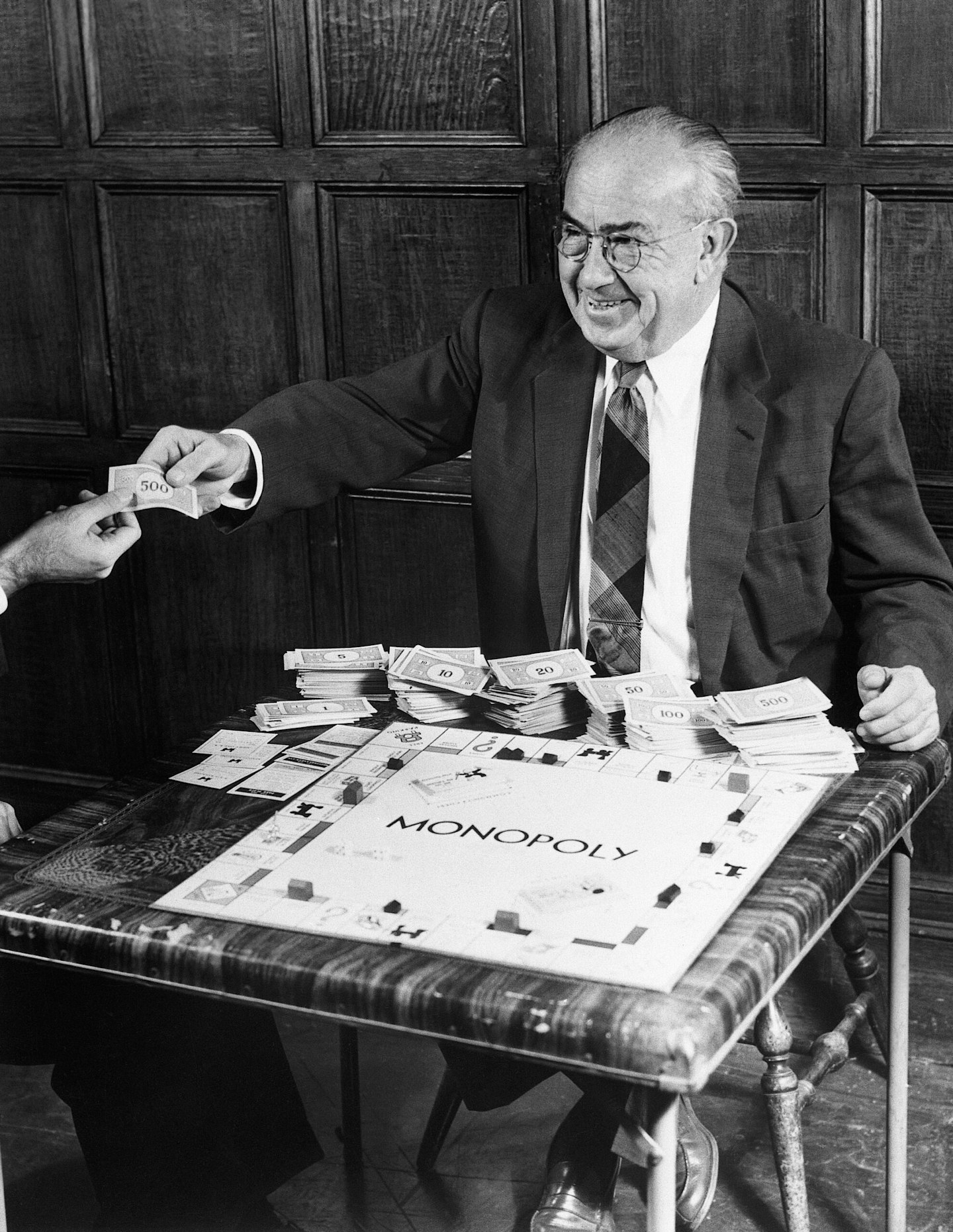 Charles B. Darrow with Monopoly board