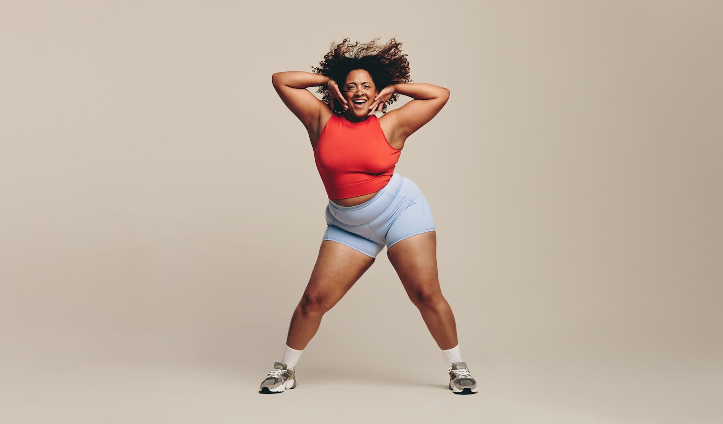 Fit woman having a blast as she moves her body in a dance workout session. Sporty woman putting her toned physique and athletic abilities on display as she lets loose with a fun physical activity