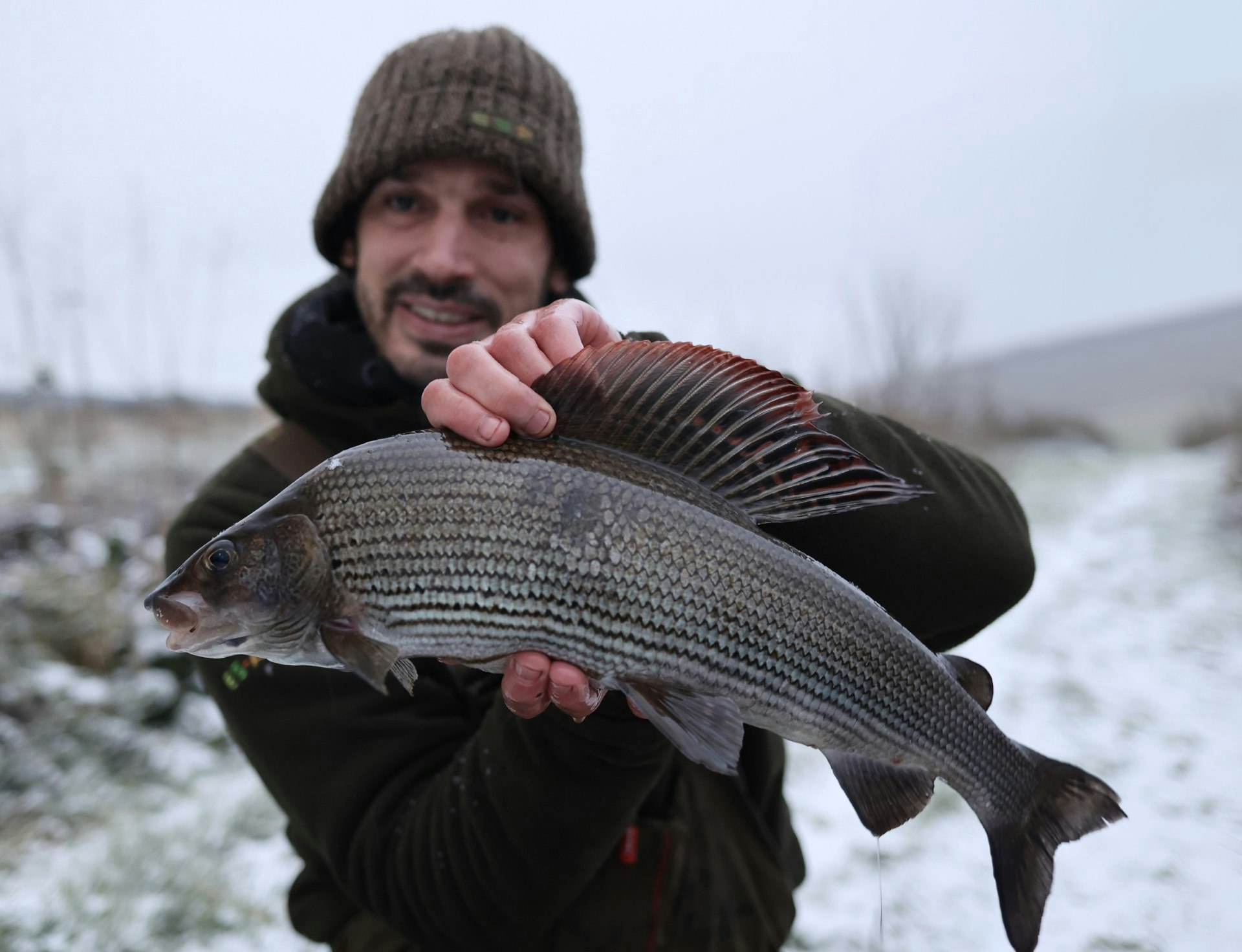 Daniel with his hard-earned grayling, what a magnificent fish it is too!