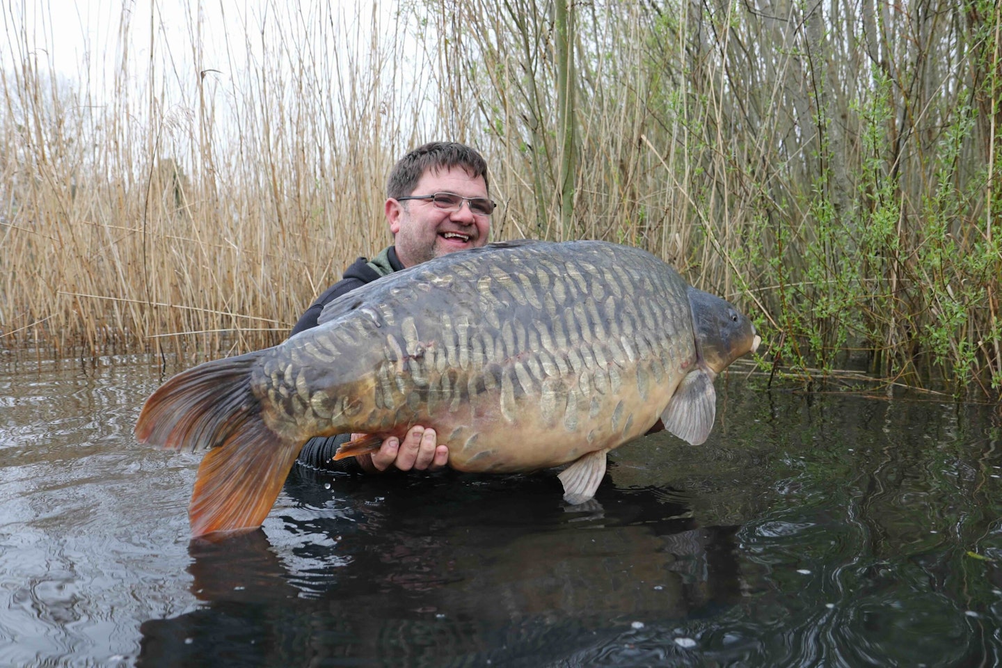 An elated, Arron Fisher holding the 'Lord' at a whopping 61lb 6oz.