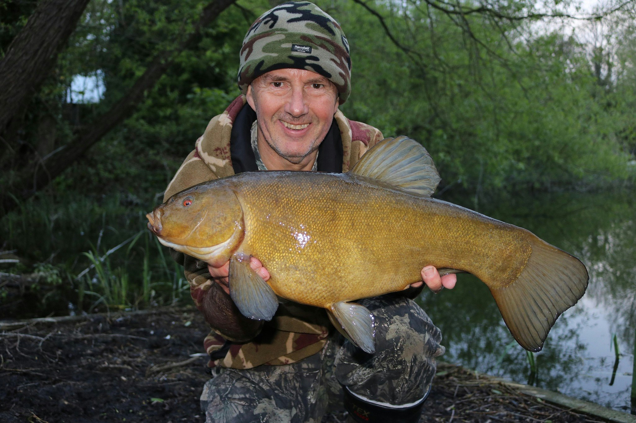 Lee Fisher with a fantastic example of a tench.