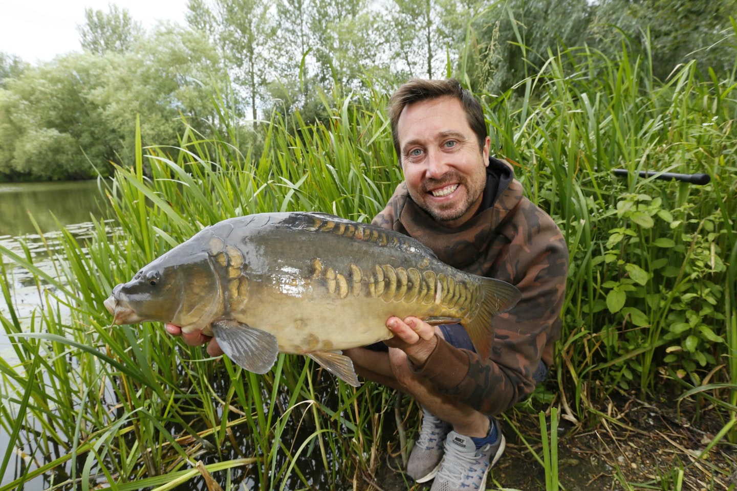 Rich with a carp caught from the margins.