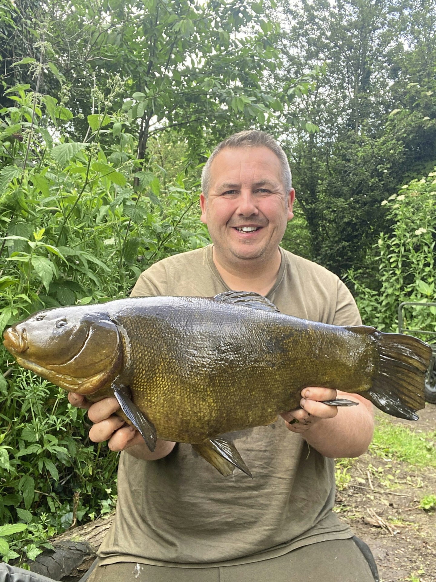 Neale Woodward and an 11lb 2oz tench.