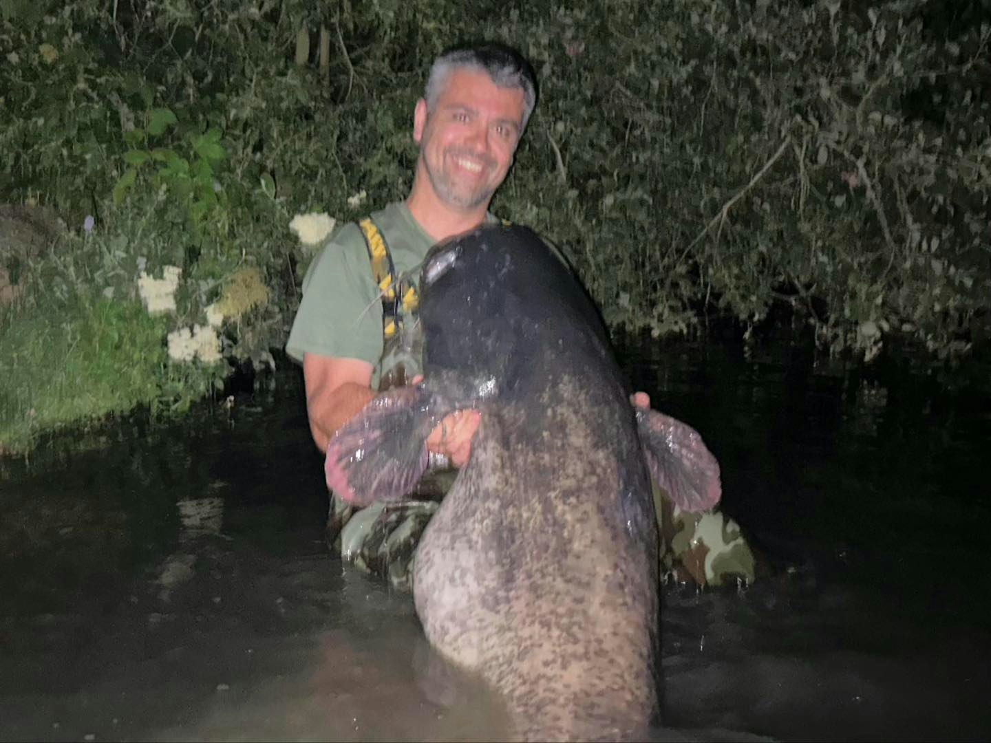 all smiles after taming such a massive catfish