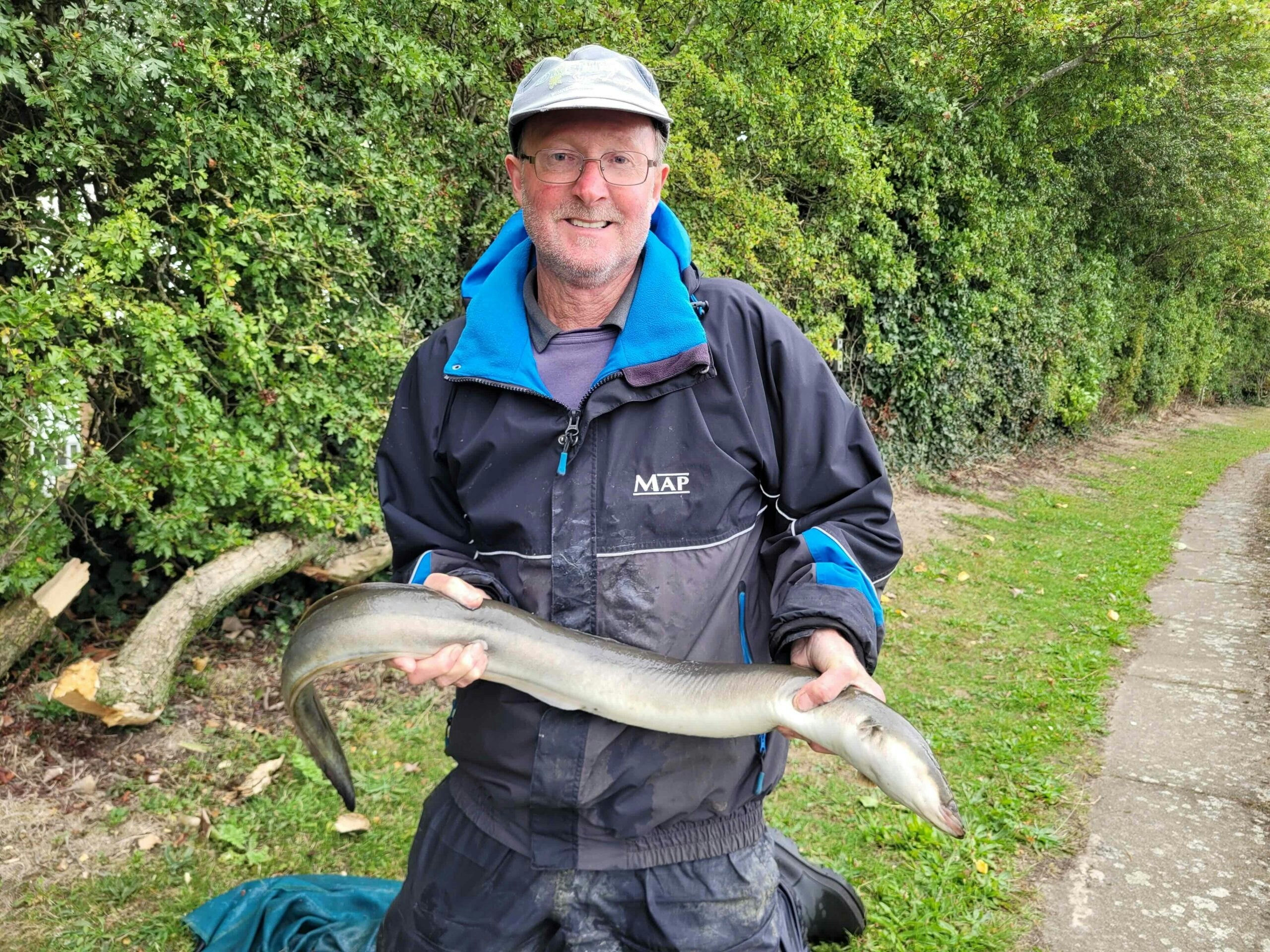 Jeff Holland with the huge eel he caught