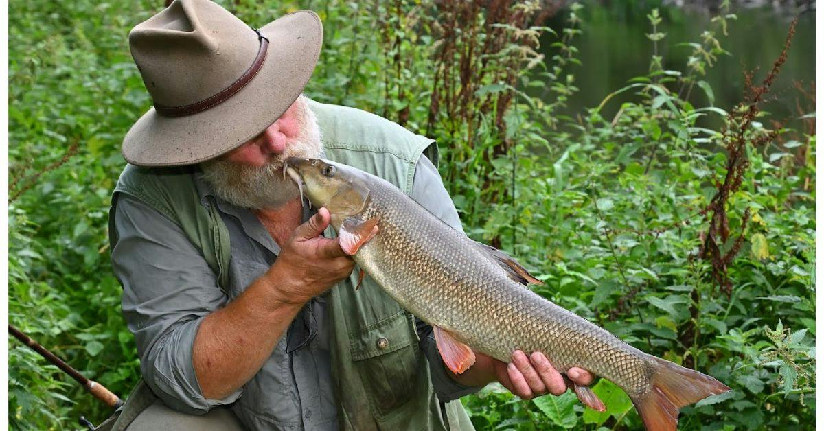 angler enjoying his catch by kissing it