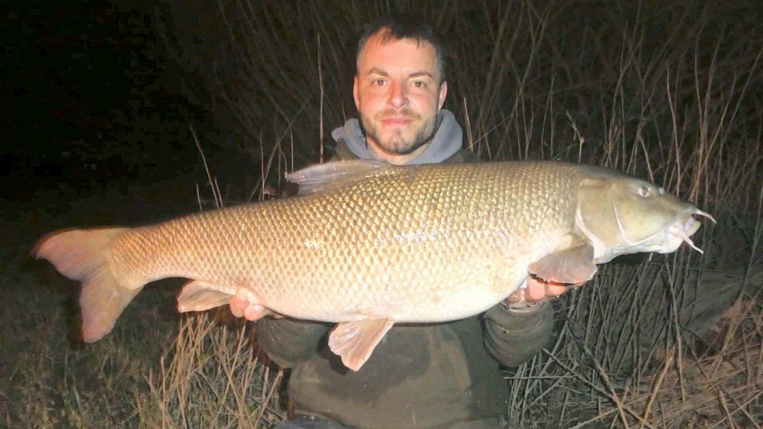 Luke holding the biggest barbel the Severn has produced