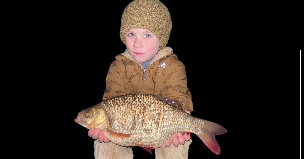 young angler holding a big rudd they caught