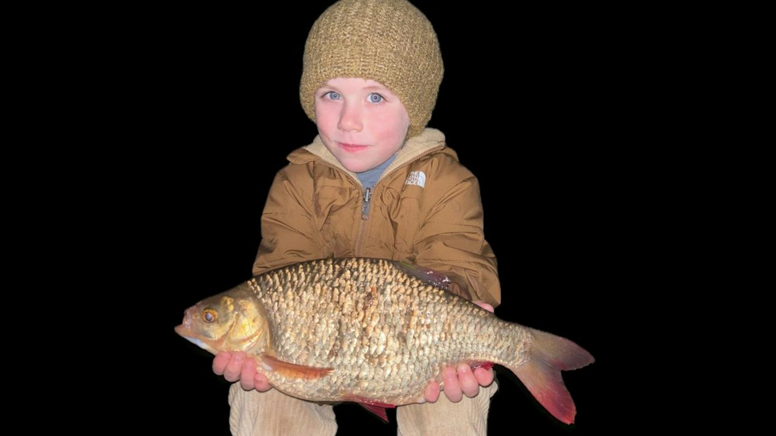 young angler holding a big rudd they caught