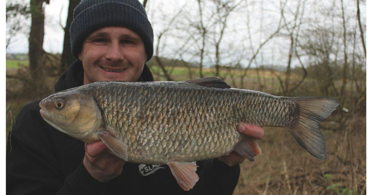 Angler holding big chub
